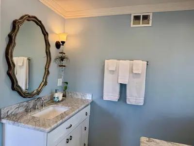 a bathroom with a sink and a mirror at Ocean Breeze Haven Sunset & Pool La Jolla in San Diego