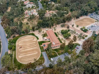an aerial view of a large field in a park at Idyllic Casita on Private Fairbanks Ranch Estate in Rancho Santa Fe
