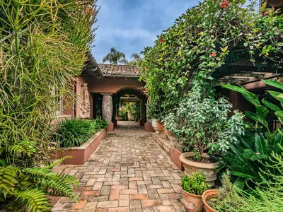 a garden with plants and a brick walkway at Idyllic Casita on Private Fairbanks Ranch Estate in Rancho Santa Fe