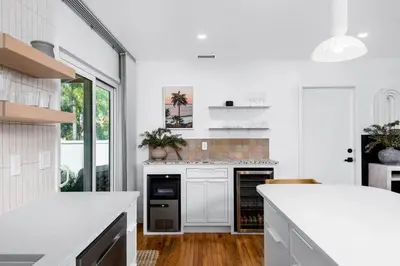a kitchen with white counters and a white counter top at Coasta Casa, Retreat by the Sea. E-Charger. in Carlsbad