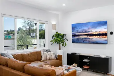 a living room with a couch and a large window at Coasta Casa, Retreat by the Sea. E-Charger. in Carlsbad