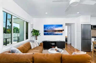 a living room with a couch and a table at Coasta Casa, Retreat by the Sea. E-Charger. in Carlsbad