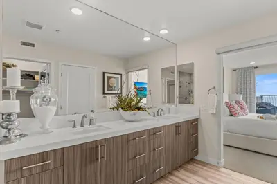 a bathroom with two sinks and a large mirror at 15 Feet to the Water in Oceanside