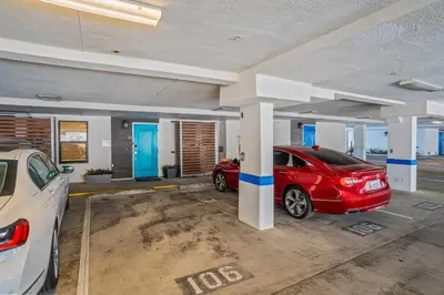 a car garage with two cars parked in it at 15 Feet to the Water in Oceanside
