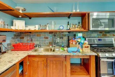 a kitchen counter with a sink and a stove at Carlsbad Rental with Private Balcony and Pool Access! in Carlsbad