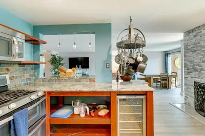 a kitchen with blue walls and a counter top at Carlsbad Rental with Private Balcony and Pool Access! in Carlsbad