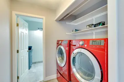 a red washing machine in a laundry room at Carlsbad Rental with Private Balcony and Pool Access! in Carlsbad