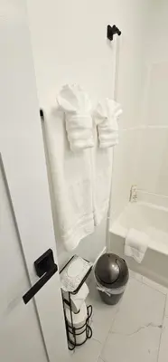 a bathroom with white towels and a bath tub at Hillcrest San Diego Canyon Oasis in San Diego