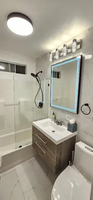 a bathroom with a sink and a toilet and a mirror at Hillcrest San Diego Canyon Oasis in San Diego