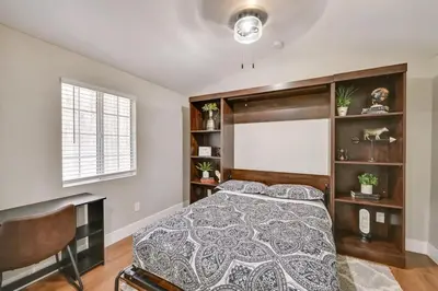 a bedroom with a bed and a chair and a window at Entire 2 Bedroom Pet Friendly Cottage Home in Alpine