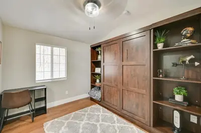 a living room with a large wooden cabinet and a window at Entire 2 Bedroom Pet Friendly Cottage Home in Alpine