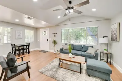 a living room with a blue couch and a table at Entire 2 Bedroom Pet Friendly Cottage Home in Alpine