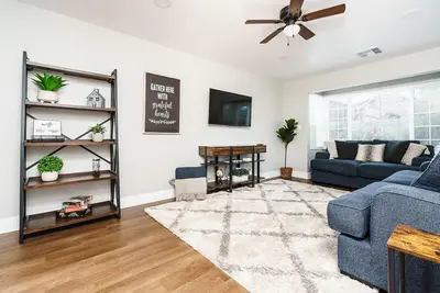 a living room with a blue couch and a tv at Entire 2 Bedroom Pet Friendly Cottage Home in Alpine