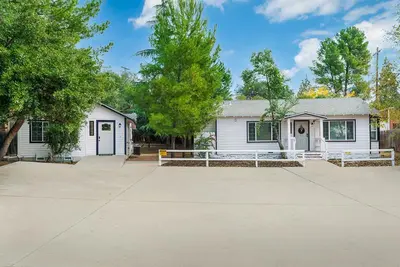 a white house with a driveway in front of it at Entire 2 bedroom Pet Friendly Guest Cottage in Alpine