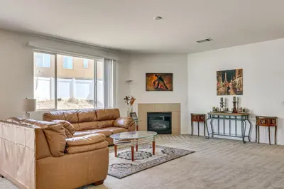 a living room with a couch and a fireplace at Large Menifee Home 1 Block to Neighborhood Park! in Menifee