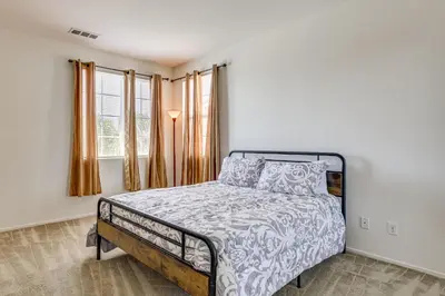 a bedroom with a bed with a bedspread on it at Large Menifee Home 1 Block to Neighborhood Park! in Menifee