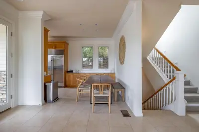 a kitchen and dining room with a table and stairs at Ocean View Del Mar Beach Home w Jacuzzi in San Diego