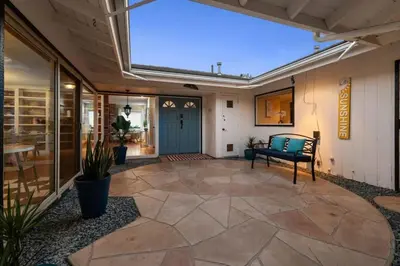 a patio with a bench in front of a building at Pacifica Paradise by Cardo - Ocean Views - AC - Kids Playground in San Diego