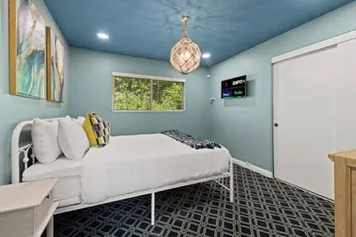a bedroom with a white bed and a window at Pacifica Paradise by Cardo - Ocean Views - AC - Kids Playground in San Diego