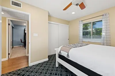 a bedroom with a bed and a ceiling fan at Pacifica Paradise by Cardo - Ocean Views - AC - Kids Playground in San Diego