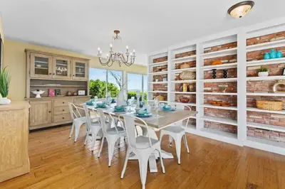 a dining room with a table and white chairs at Pacifica Paradise by Cardo - Ocean Views - AC - Kids Playground in San Diego