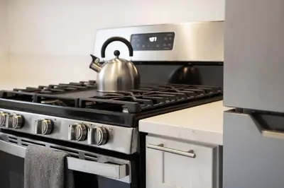 a tea kettle sitting on top of a stove in a kitchen at Coastal Haven - Prime Spot Walk to Beach in San Diego