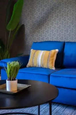 a blue couch with a coffee table in a living room at Coastal Haven - Prime Spot Walk to Beach in San Diego