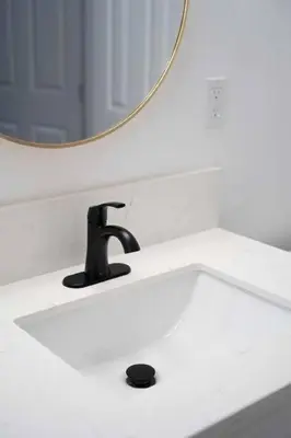 a bathroom sink with a mirror and a faucet at Coastal Haven - Prime Spot Walk to Beach in San Diego