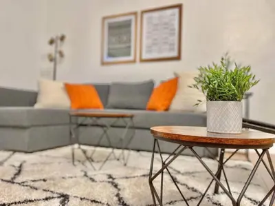 a living room with a couch and two tables at San Diegos Best Zoo, SeaWorld and Downtown Nearby in San Diego