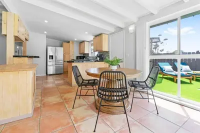 a kitchen and dining room with a table and chairs at Relax and Play Pool, Hot Tub and Sleeps 16 in San Diego