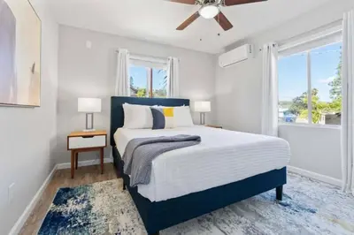 a bedroom with a bed and a ceiling fan at 15 min to San Diego! Walk to Trolley in El Cajon