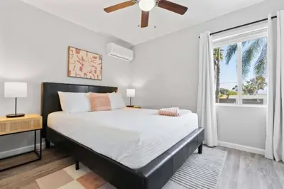 a bedroom with a large bed and a window at 15 min to San Diego! Walk to Trolley in El Cajon