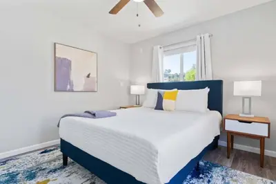 a bedroom with a large bed and a window at 15 min to San Diego! Walk to Trolley in El Cajon