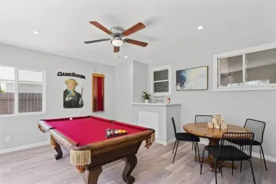 a living room with a pool table and a dining area at Relax and Play Pool Table, Hot Tub and Mini Golf Fun! in La Mesa
