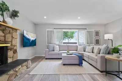 a living room with a couch and a fireplace at Relax and Play Pool Table, Hot Tub and Mini Golf Fun! in La Mesa