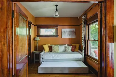 a bedroom with two beds in a room at 1907 Stone House - King Bed, Office, Crib, Toys in San Diego