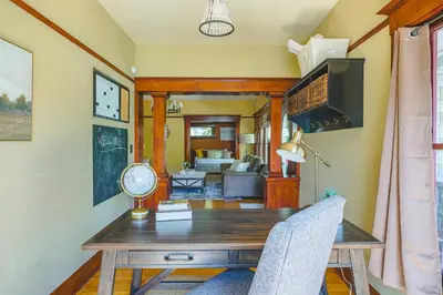 a dining room with a wooden table and chairs at 1907 Stone House - King Bed, Office, Crib, Toys in San Diego