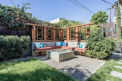 a patio with a bench and a table in a yard at 1907 Stone House - King Bed, Office, Crib, Toys in San Diego
