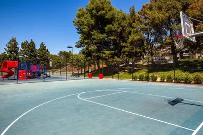 a basketball court with a basketball hoop on it at Shabby Chic Oceanside King & 2 Queen bed Pool GYM in Oceanside