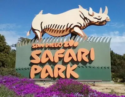 a sign for a safari park with a rhino on it at Shabby Chic Oceanside King & 2 Queen bed Pool GYM in Oceanside