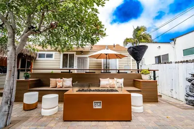 a patio with a table and chairs and an umbrella at Pacific Beach Bungalow Just Steps to Beach in San Diego