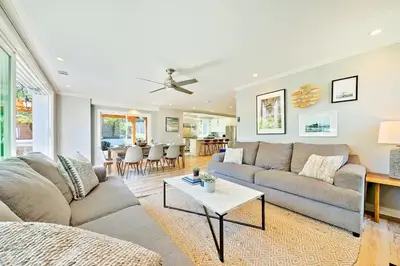 a living room with a couch and a table at Outdoor Haven with Spa Walk to La Jolla Shores Beach in San Diego