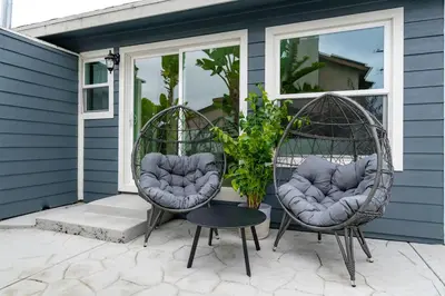 two wicker chairs and a table on a patio at Outdoor Haven with Spa Walk to La Jolla Shores Beach in San Diego