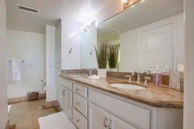 a bathroom with a sink and a large mirror at Aloha Breeze 1 in San Diego