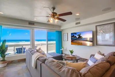 a living room with a couch and a view of the ocean at Aloha Breeze 1 in San Diego