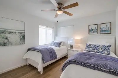 a bedroom with two beds and a ceiling fan at Avalon Beach 2 in San Diego
