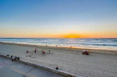 a group of people on the beach at sunset at Aqua in San Diego