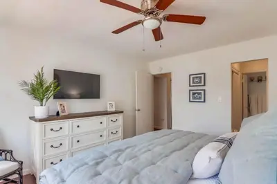 a bedroom with a bed and a ceiling fan at Avalon Beach 3 in San Diego