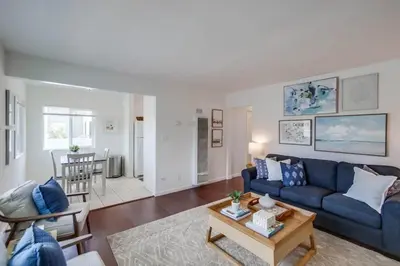 a living room with a blue couch and a table at Avalon Beach 4 in San Diego