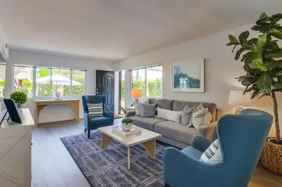 a living room with a couch and chairs and a table at Avalon Beach 1 in San Diego
